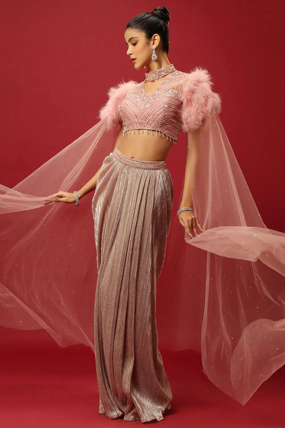 PETAL PINK DRAPED SKIRT SET AND A HAND EMBROIDERED BLOUSE WITH ATTACHED CAPE SLEEVES AND A FEATHER SHOULDER DETAIL