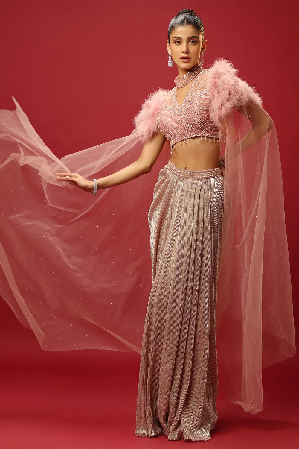 PETAL PINK DRAPED SKIRT SET AND A HAND EMBROIDERED BLOUSE WITH ATTACHED CAPE SLEEVES AND A FEATHER SHOULDER DETAIL