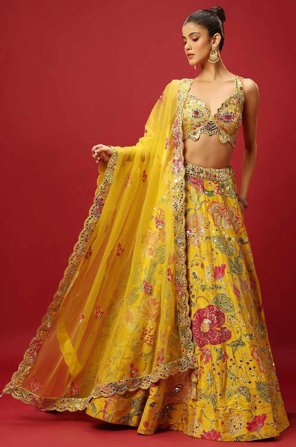 SUNSHINE YELLOW CLASSIC PRINTED LEHENGA SET AND A MIRROR WORK BLOUSE PAIRED WITH A MATCHING DUPATTA AND ALL OVER MIRROR WORK DETAILS.