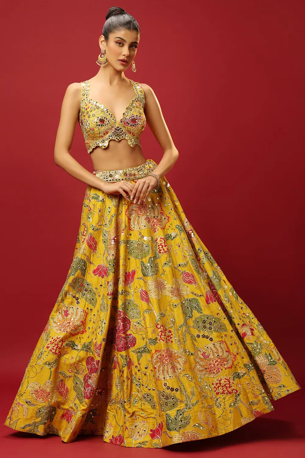 SUNSHINE YELLOW CLASSIC PRINTED LEHENGA SET AND A MIRROR WORK BLOUSE PAIRED WITH A MATCHING DUPATTA AND ALL OVER MIRROR WORK DETAILS.