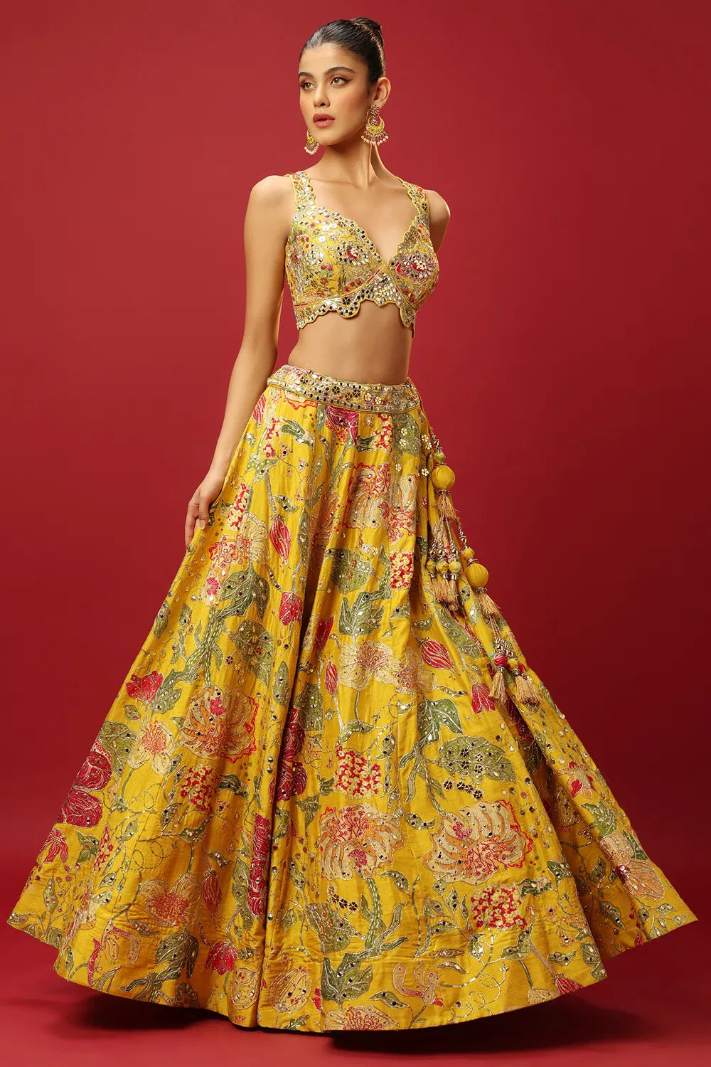 SUNSHINE YELLOW CLASSIC PRINTED LEHENGA SET AND A MIRROR WORK BLOUSE PAIRED WITH A MATCHING DUPATTA AND ALL OVER MIRROR WORK DETAILS.